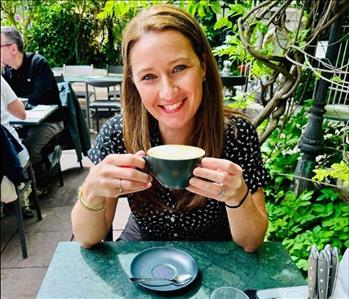 Lady enjoying a cup of coffee outdoors