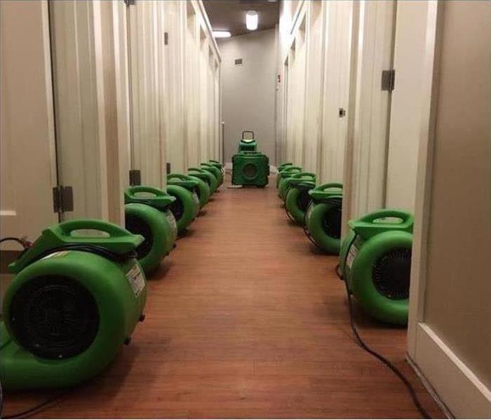 Air movers placed in a hallway of a building