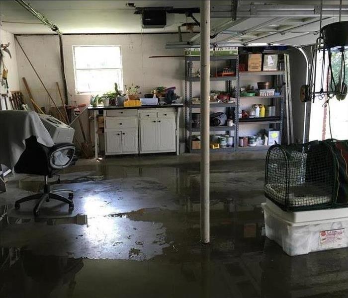 Picture of a garage. Wet floor, concept of water damage to a garage