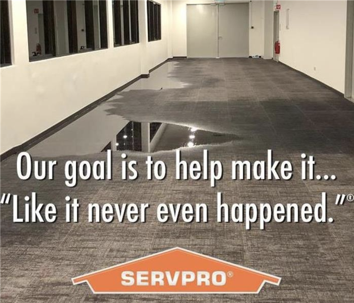 Flooded hallway with SERVPRO logo that says Our goal is to help make it... "Like it never even happened."